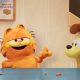 garfield voice of chris pratt talking to the camera while odie harvey guillen sits beside him looking happy in the garfield movie 80x80